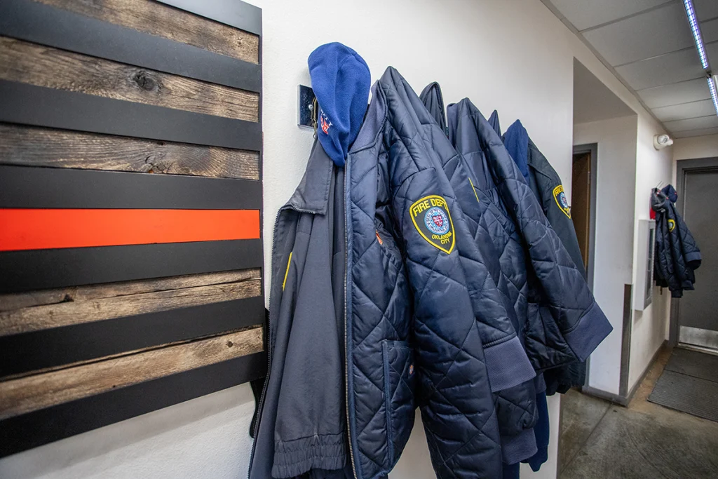 firefighter coats hanging on the wall.